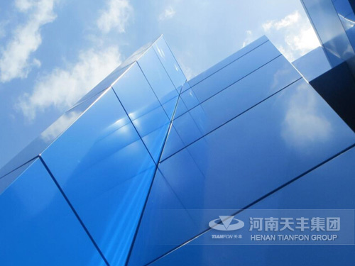 Glass surface and metallic curtain wall panel